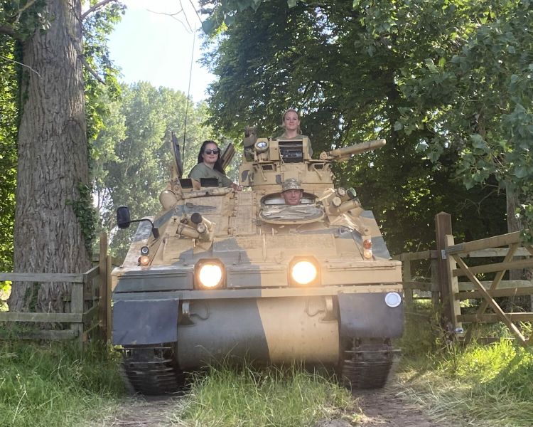 two people driving a tank on tank driving experience