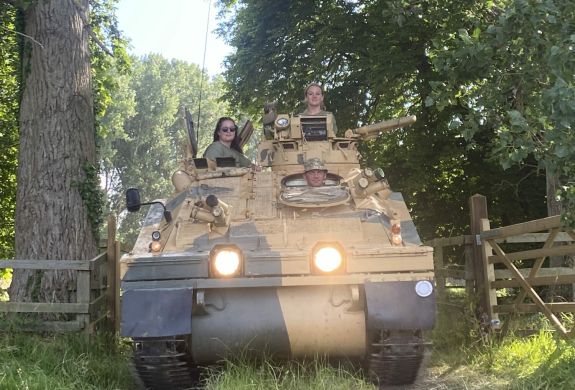 two people driving a tank on tank driving experience