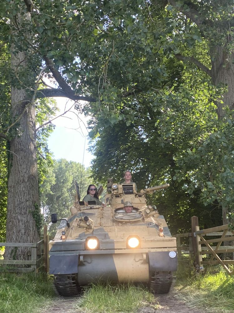 two people driving a tank on tank driving experience
