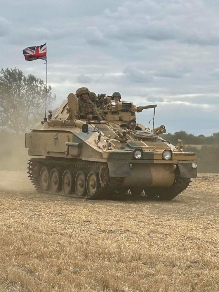 a tank being driven across a muddy field on tank driving experience day