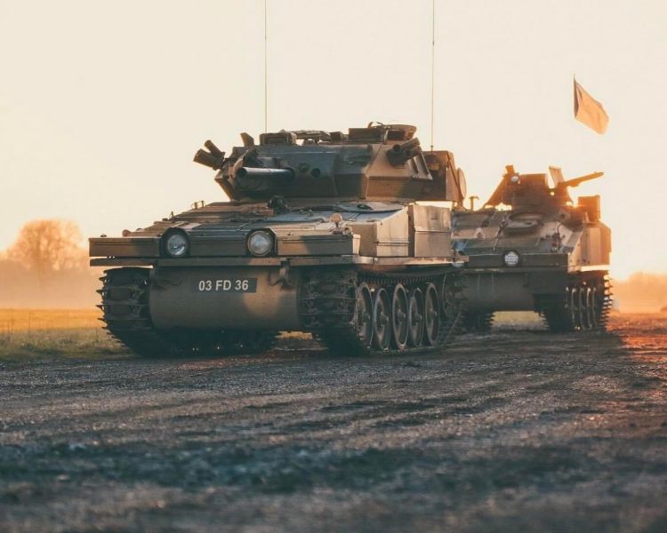 man driving a tank on a scorpion firing tank driving experience day