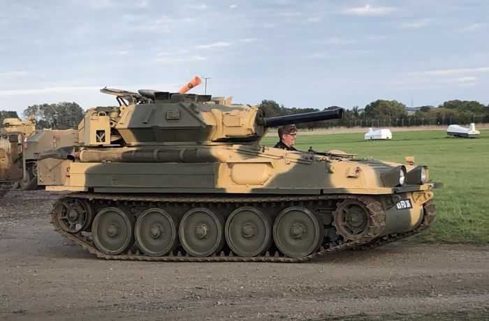 man driving a tank on a scorpion firing tank driving experience day