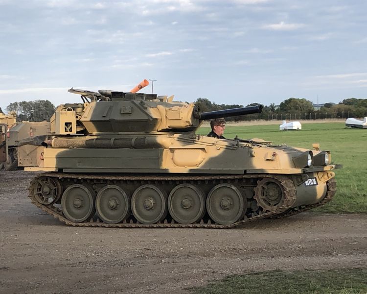 man driving a tank on a scorpion firing tank driving experience day