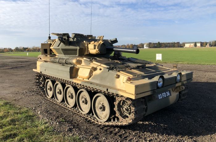 man driving a tank on a scorpion firing tank driving experience day