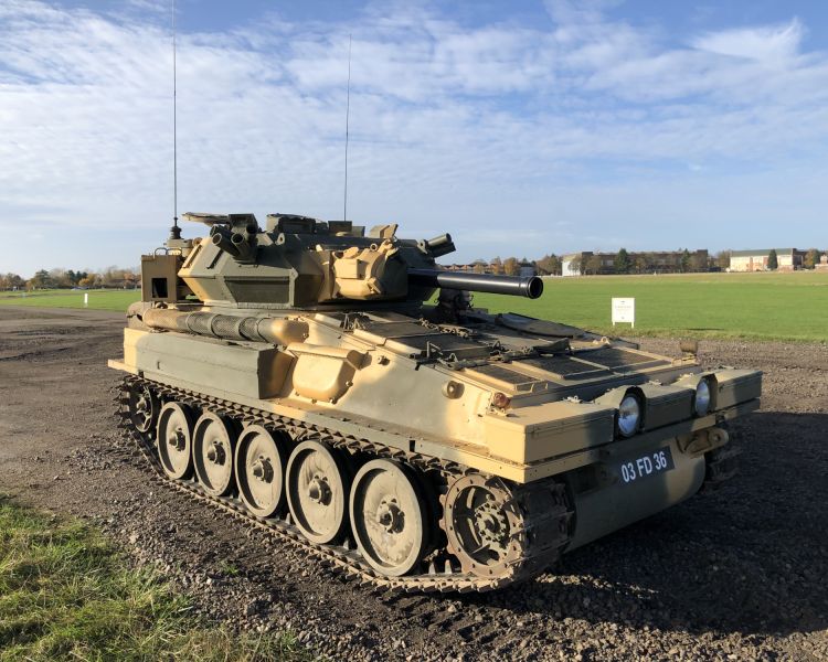 man driving a tank on a scorpion firing tank driving experience day
