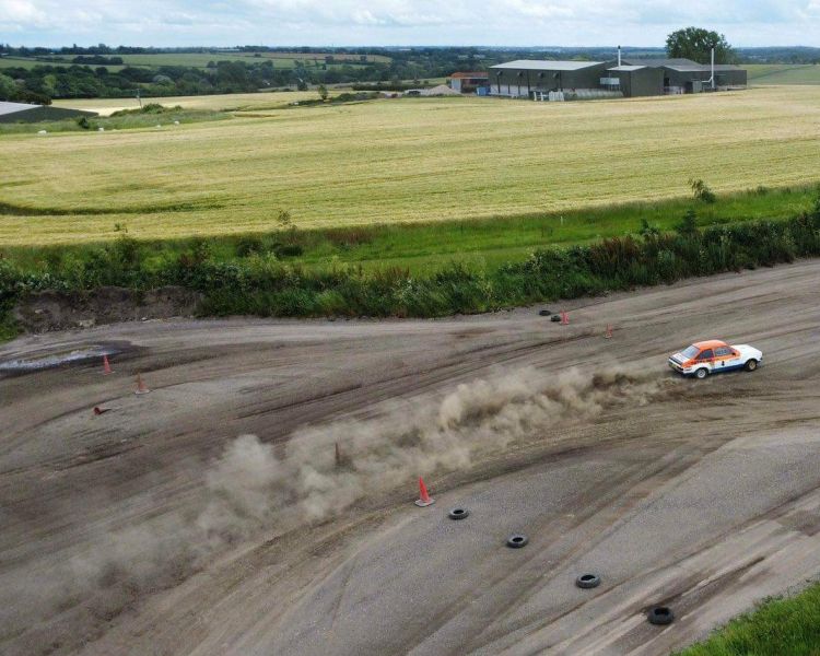 a birds eye view of a rally car being driven on a gravel track on a rally driving experience day