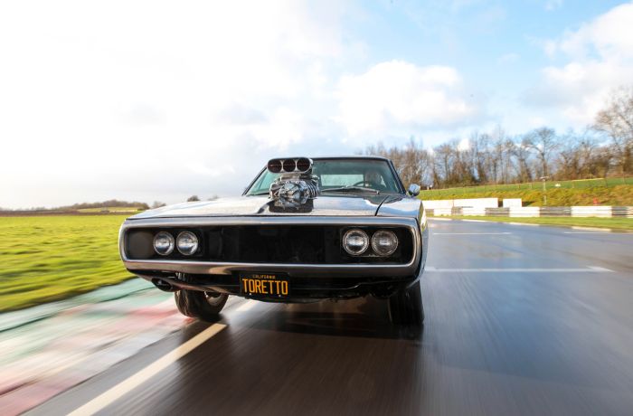 replica of dom's charger from the fast and the furious film on a race track for a movie cars driving experience day