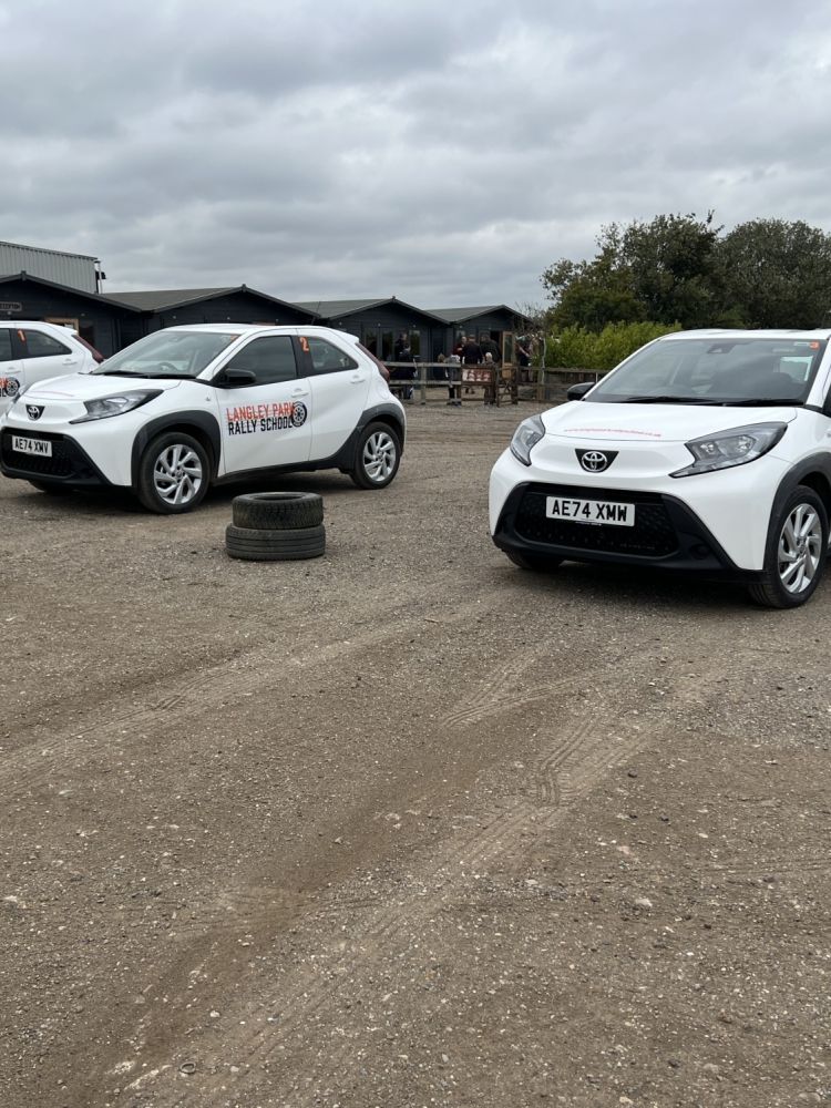 a line up of toyota aygos ready for a junior driving experience