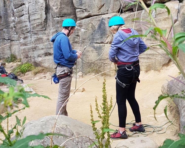 A man and woman preparing at Intro to Climbing Hatt Adventures