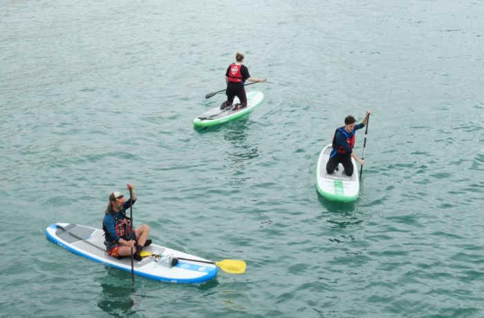 3 people paddle boarding at SUP Hatt Adventures