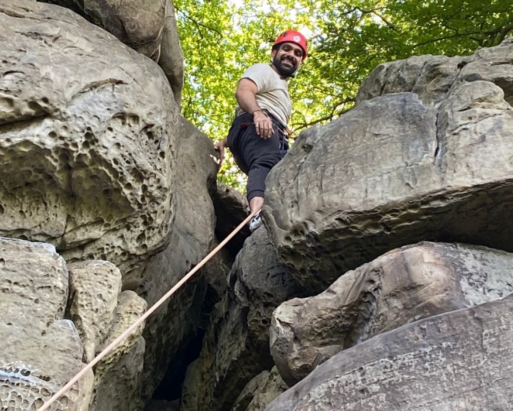 Low view of a man on top of some rocks Climbing Exp Hatt Adventures