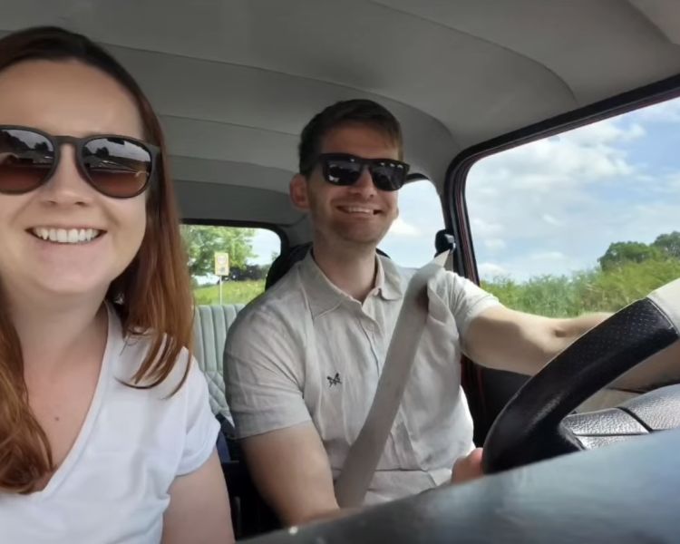 a man and a woman driving a classic red mini cooper on a self drive road trip