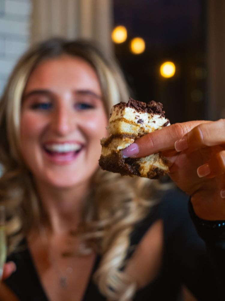 A close up of a woman holding cake