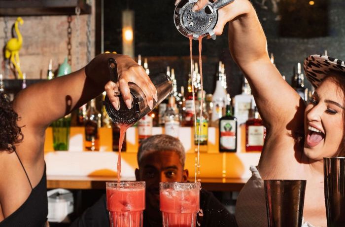 2 female bartenders pouring cocktails