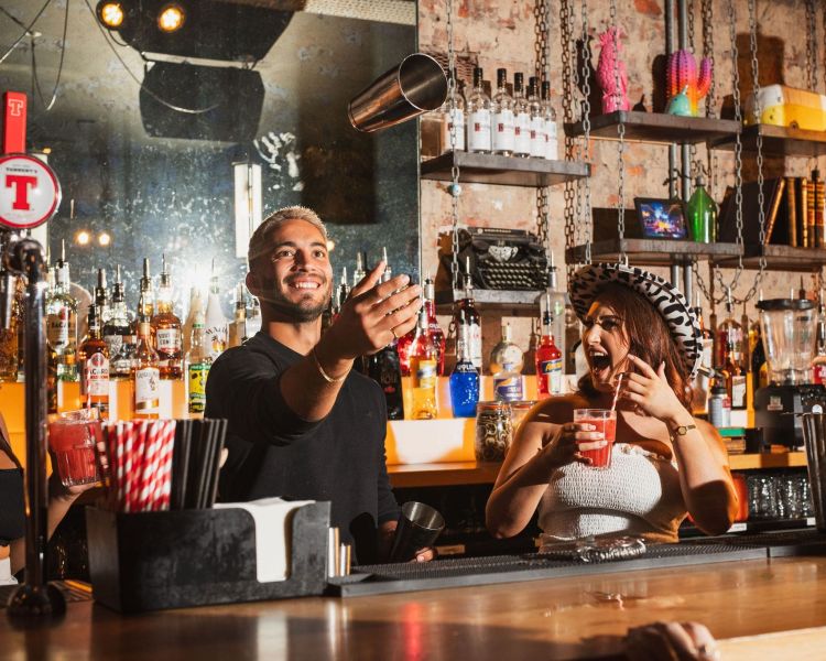 a bartender doing tricks while making drinks