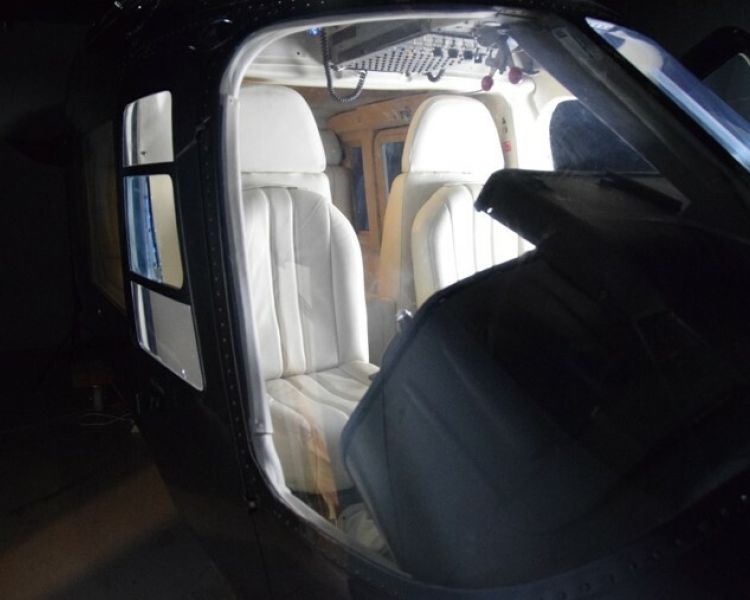 looking into the seating area in a helicopter lit up in the dark