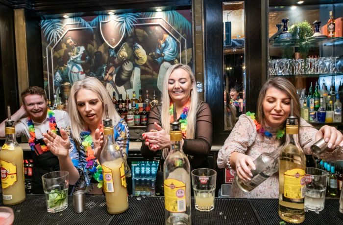 three ladies mixing cocktails on a cocktail masterclass at revolucion de cuba