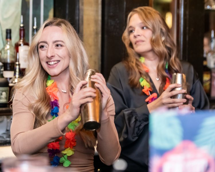 two women shaking cocktails on a cocktail masterclass at revolucion de cuba