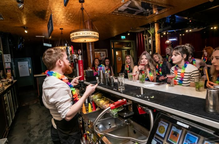 people watching  bartender behind the bar on a cocktail masterclass at revolucion de cuba