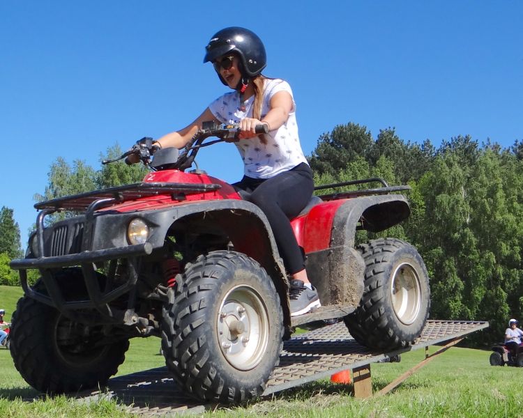 A woman smiling on a Quad Bike