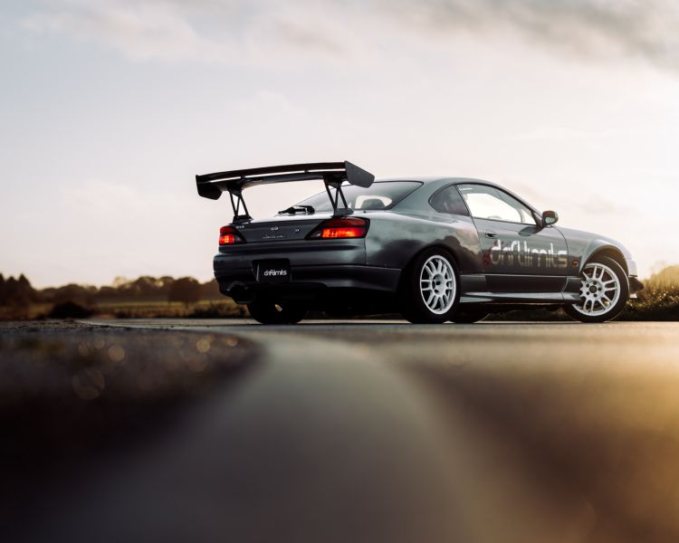 a grey nissan silvia s15 on the track for a drift legends driving experience day