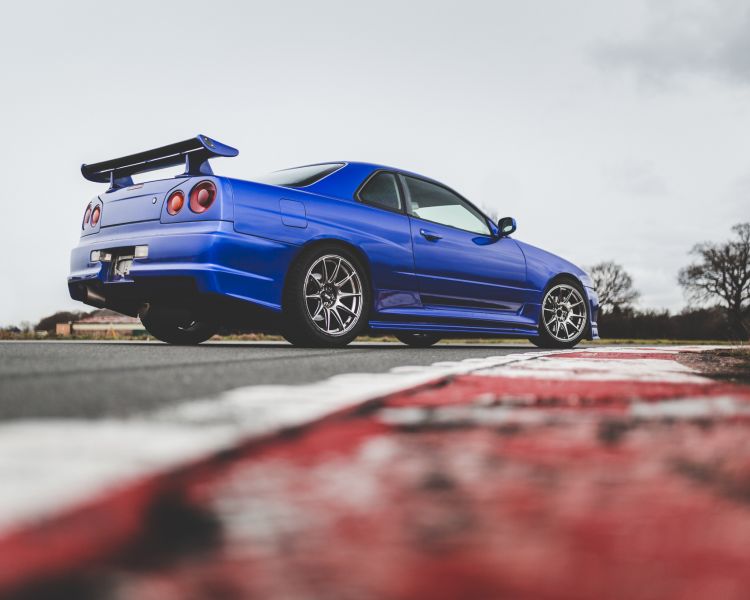 a blue r34 nissan skyline on the track for a drift legends driving experience day