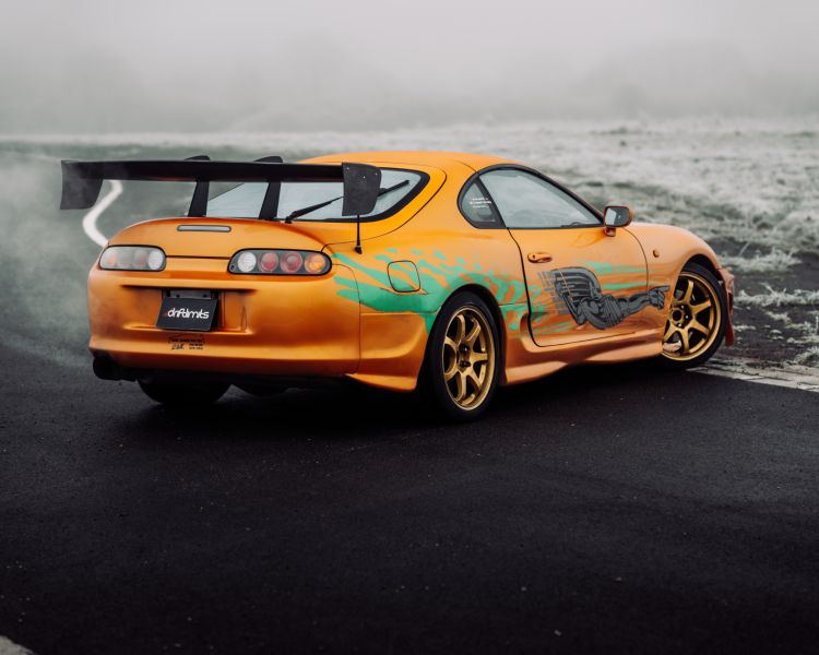 a shot of the back of a toyota supra on the track for a drift legends driving experience day
