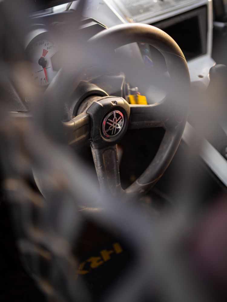 a close up of the steering wheel of a yamaha xyz1 000r dakar rally prepared yamaha on a jump and dirt driving experience