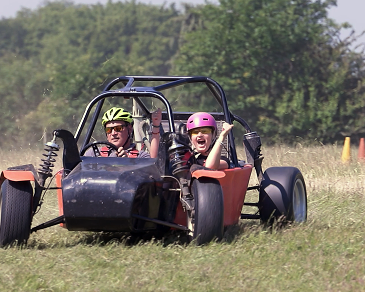 a youngster enjoying a passenger ride in an apache rally car on a junior driving day