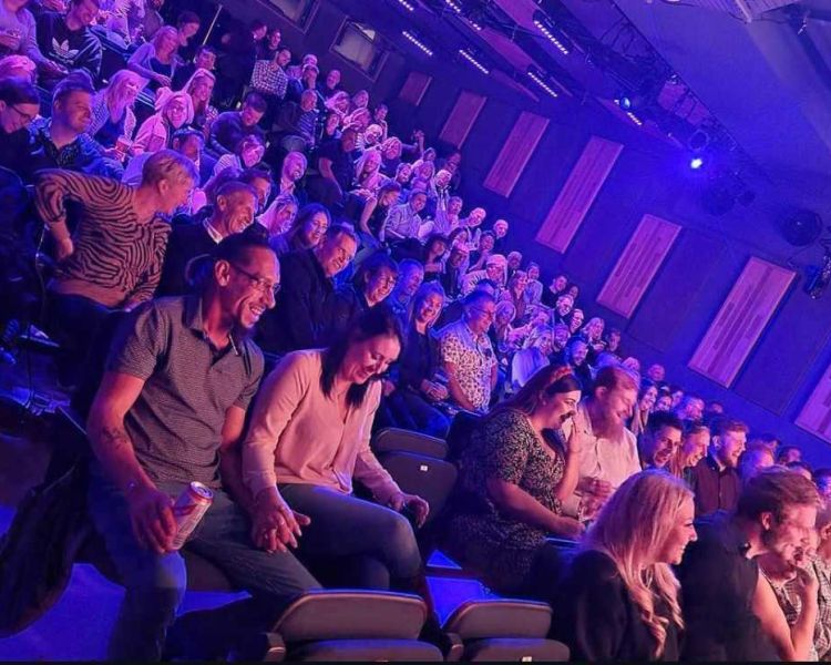 an audience enjoying a comedy night