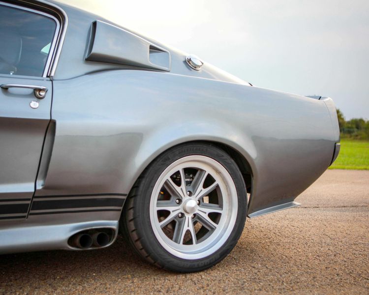 a close up of the back end of a silver vintage sports car as part of a driving experience day