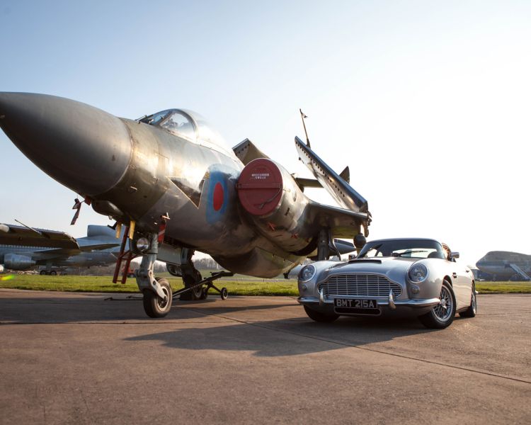 classic car next to a vintage plane on a track as part of a driving experience day gift