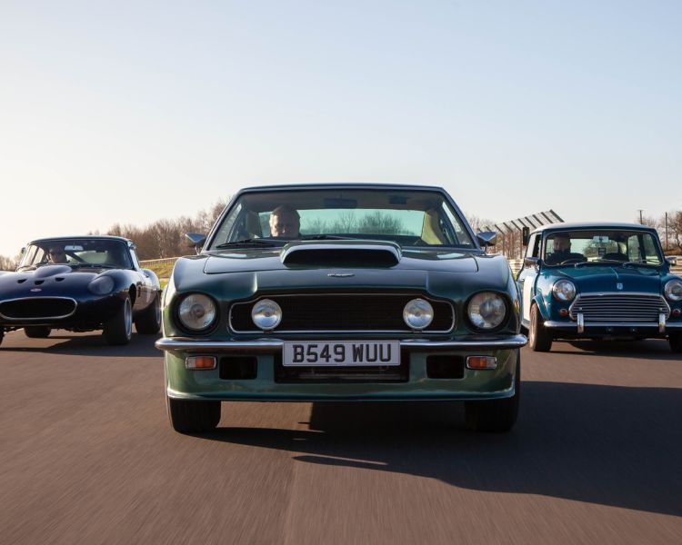 three british classic cars on a race track for a driving experience day