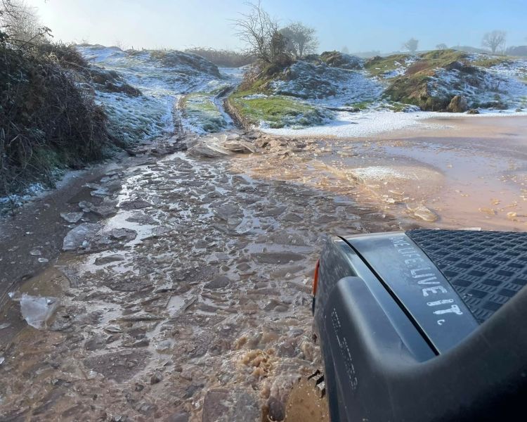 a photo taken out the passenger window of a 4x4 looking out onto a snowy beach as part of an off road driving experience