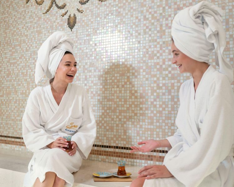 Women wearing sunglasses and head towels