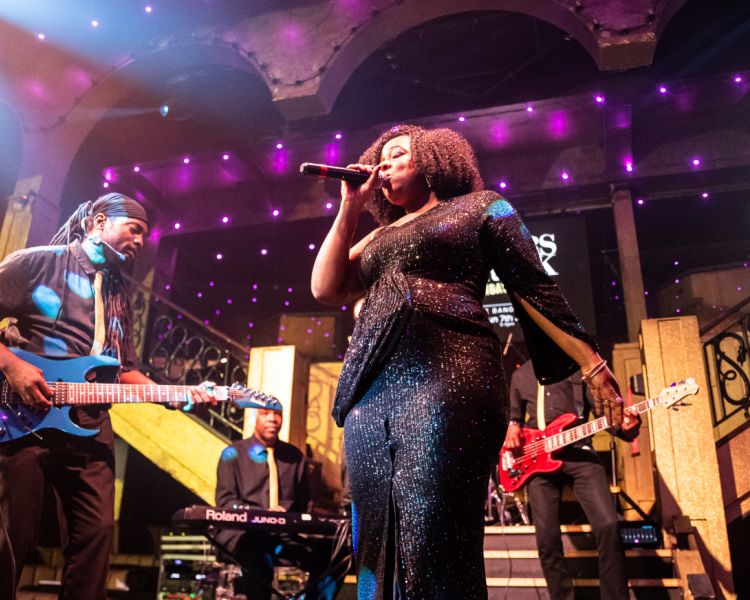 Singer and musicians on stage at a reggae live music show