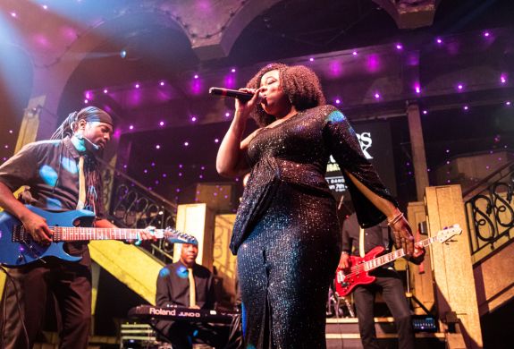 Singer and musicians on stage at a reggae live music show