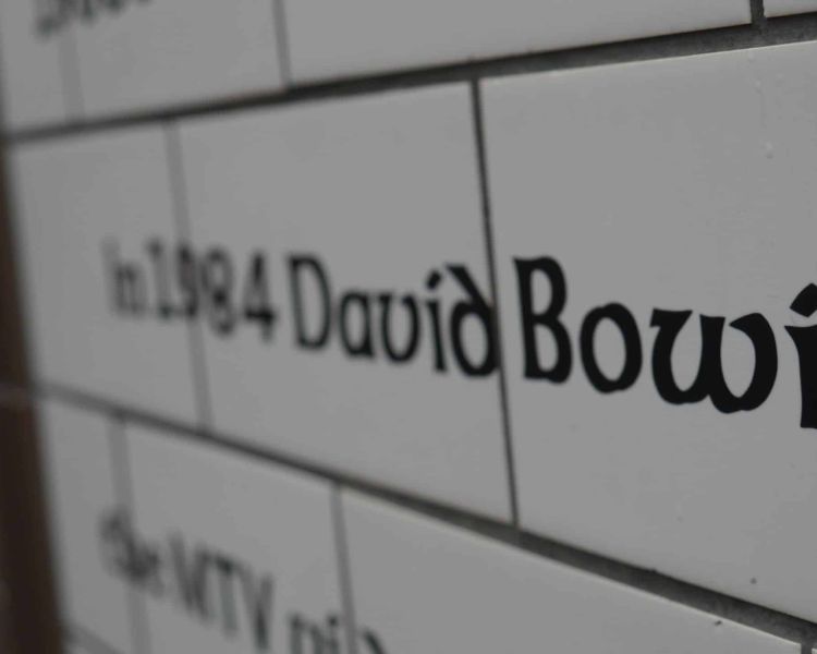 close up of wall tiles with david bowie written on them seen on the david bowie tour in london