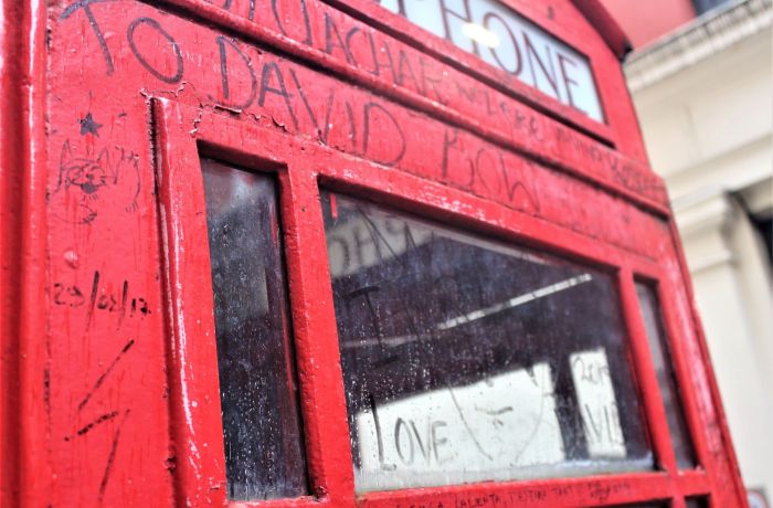 a graffitied phone box seen on the david bowie tour in london
