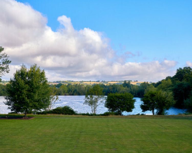 the lawn and lake in the gardens of the crowne plaza hotel in marlowe