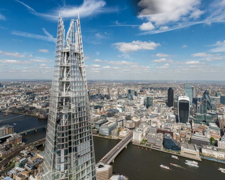 a view of the top of the shard looking out over the london skyline on a bright sunny day