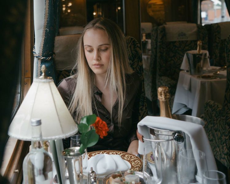 Woman sitting at table by window