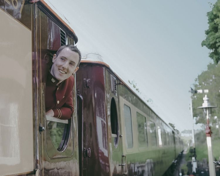 Train steward looking out of carriage window