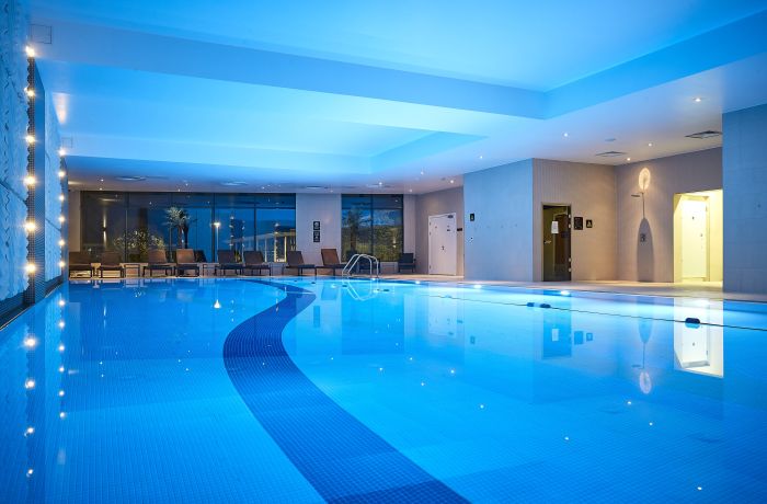 the indoor swimming pool lit up with blue lights at the crowne plaza hotel in reading