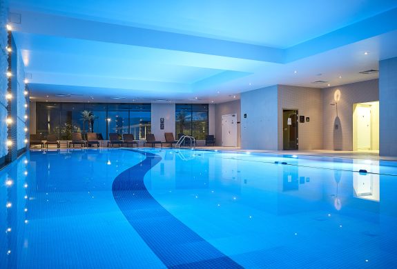 the indoor swimming pool lit up with blue lights at the crowne plaza hotel in reading