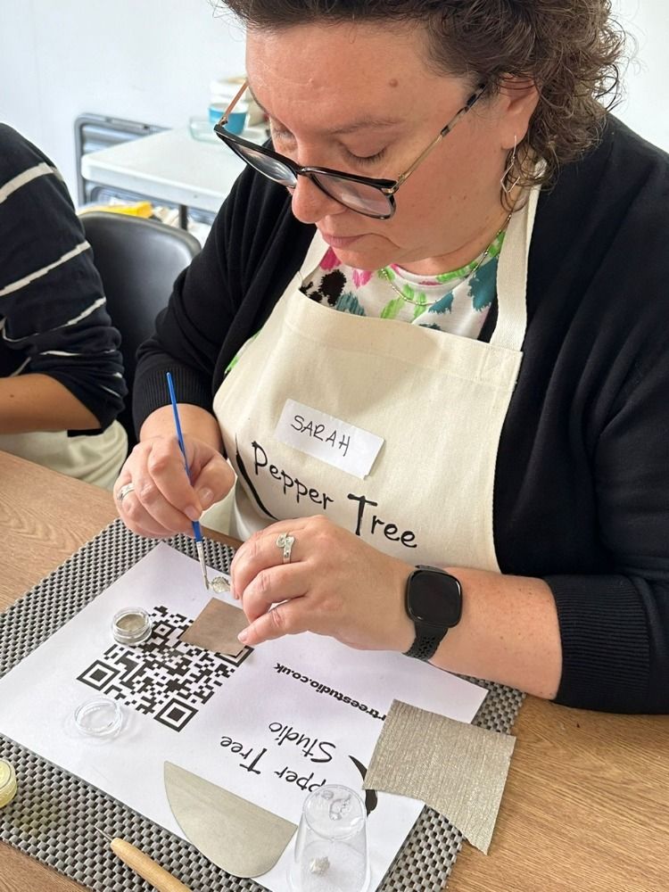 a woman at a silver clay workshop working on her piece