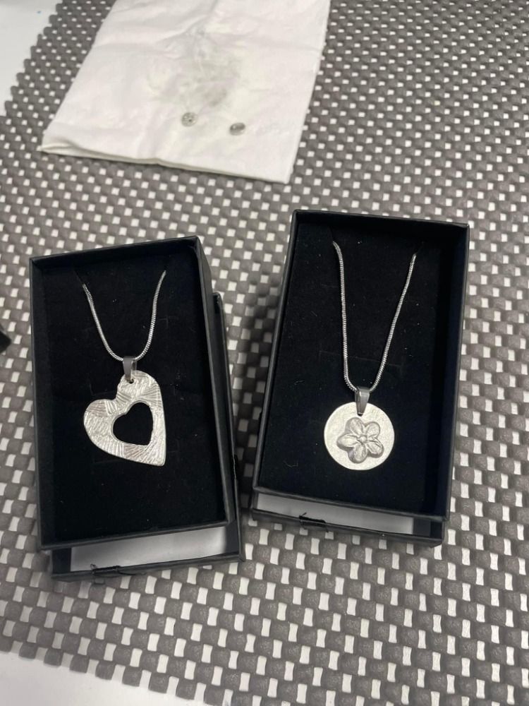 two examples of pendant necklaces made from silver clay