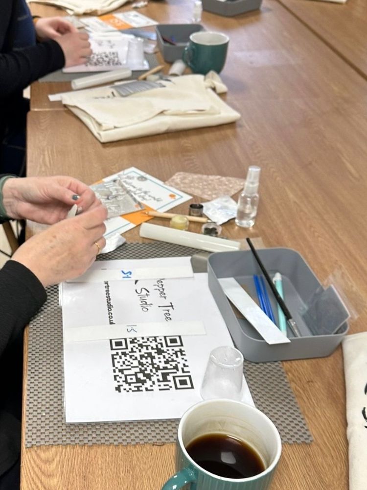 a woman working on her piece of jewellery made from silver clay on a workshop experience