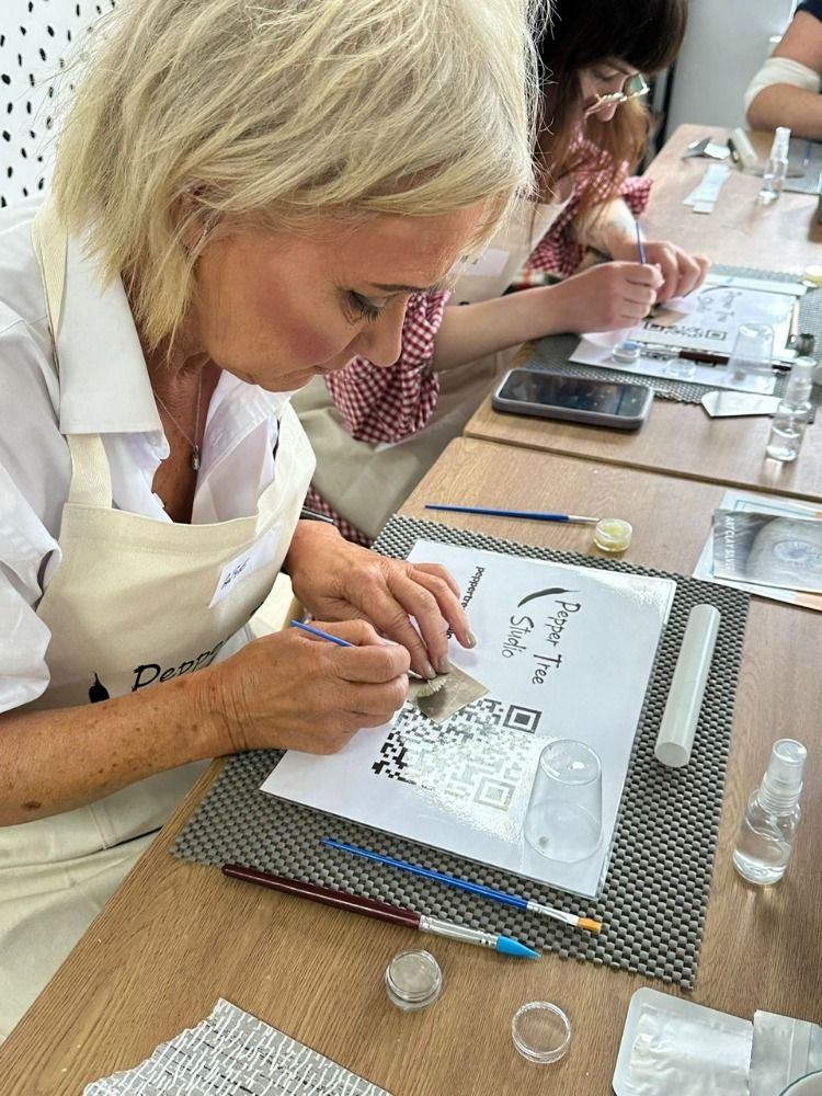 a woman at a silver clay workshop working on her piece of jewellery