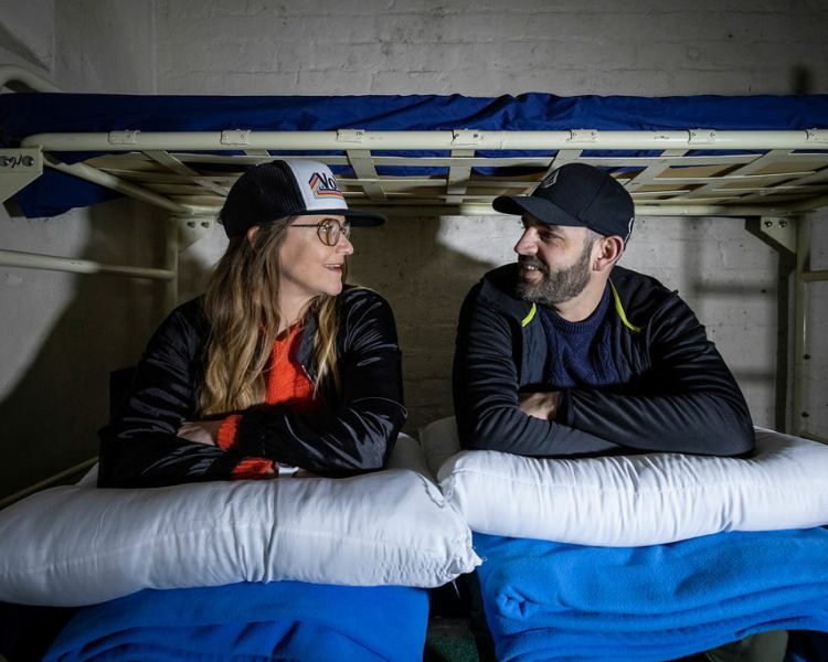 a man and a woman ready for a night behind bars experience in former prison